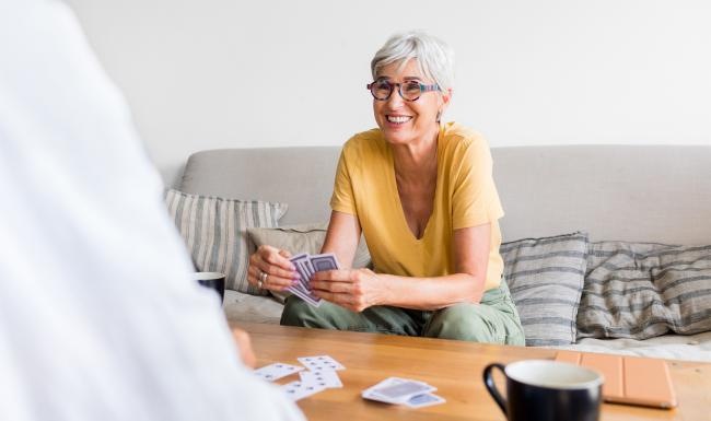 a person sitting on a couch playing cards
