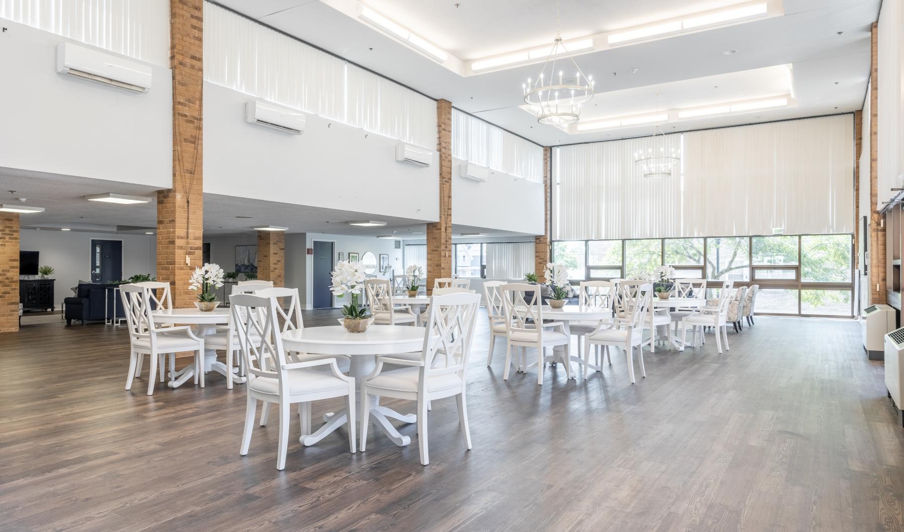 a large dining room with a table and chairs