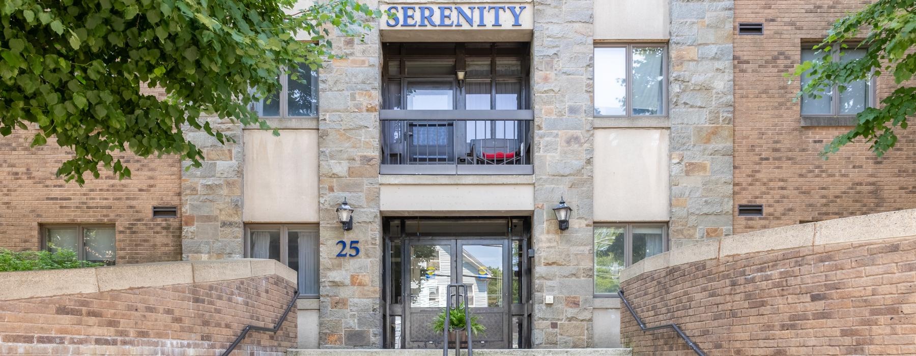 a building entrance with stairs and a door