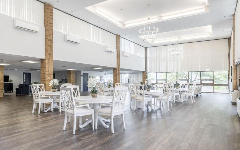 a large dining room with tables and chairs